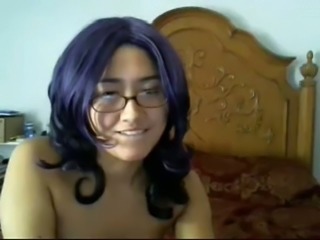 Cute dark purple haired cutie in glasses poses topless on webcam